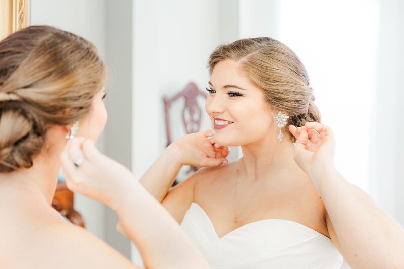 Bride smiles while looking in the mirror