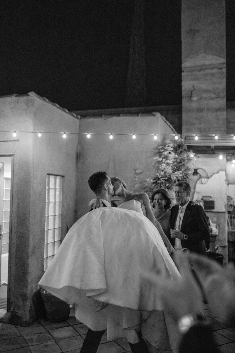 groom carrying the bride at a wedding reception