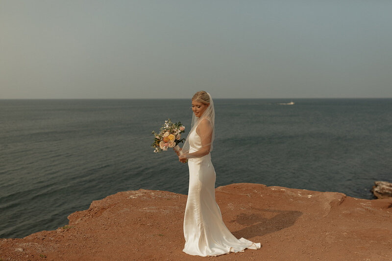 bride poses for portrait on her elopement day in pei