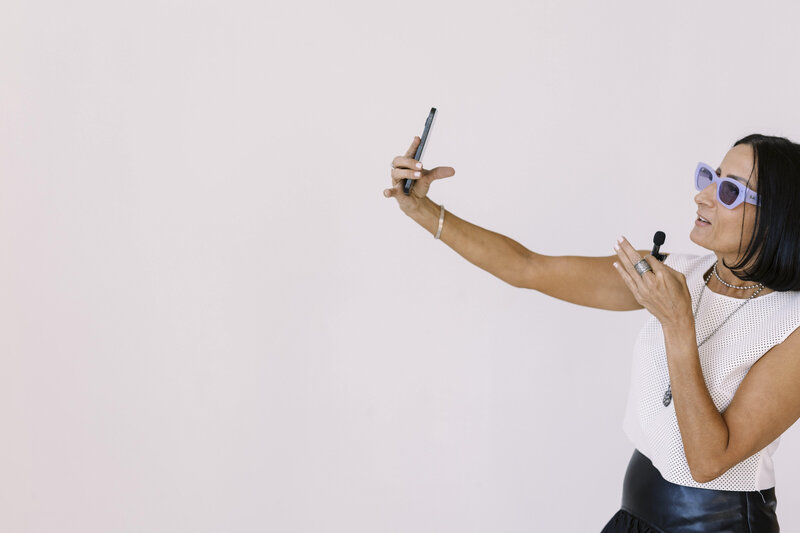 Tarah Baiman recording Instagram story holding tiny microphone