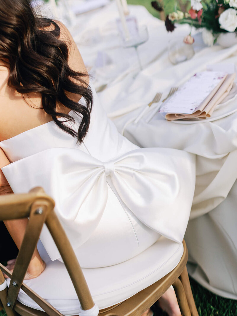 wedding dress detail of bow on back of bride's dress