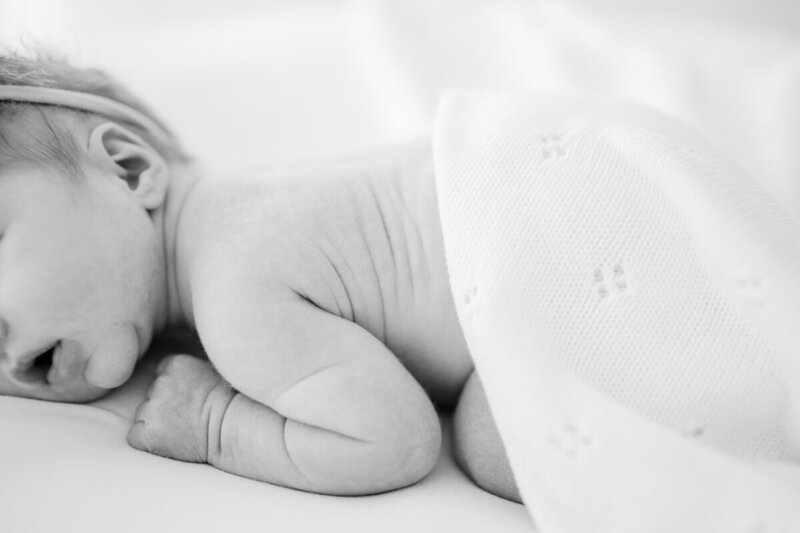 newborn baby laying on stomach showing close-up on wrinkles