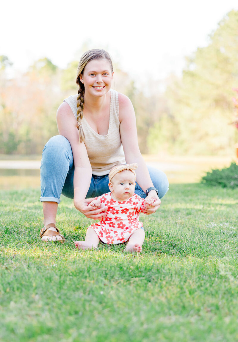 Mother and daughter sitting in the grass during golden hour for family photography in fayetteville NC park