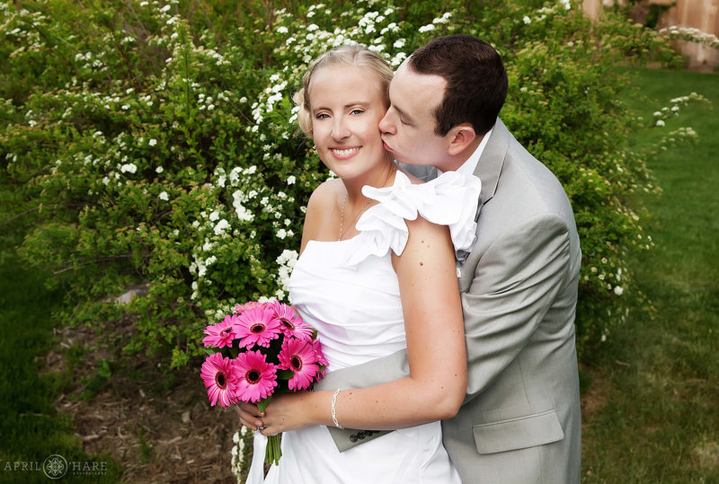 Sweet wedding portrait at The Avery House in Fort Collins with springtime blossoms in the garden