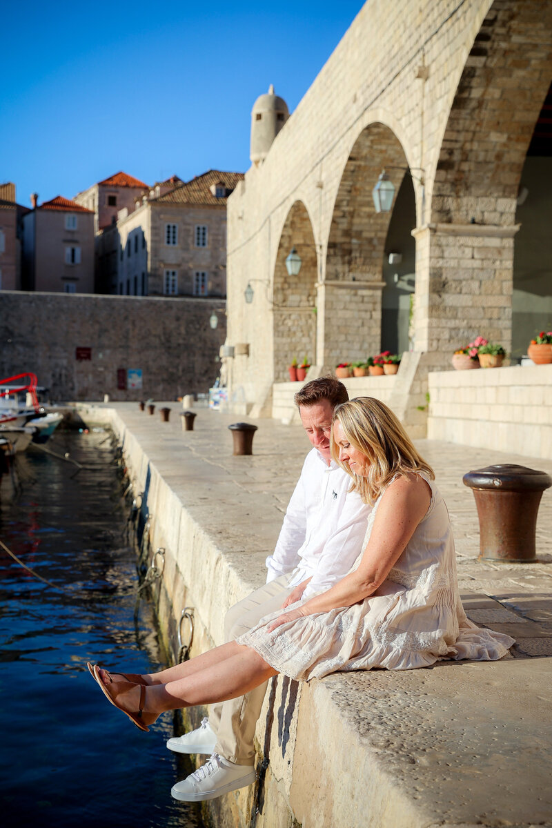 Dubrovnik Croatia Flytographer us sitting on dock 