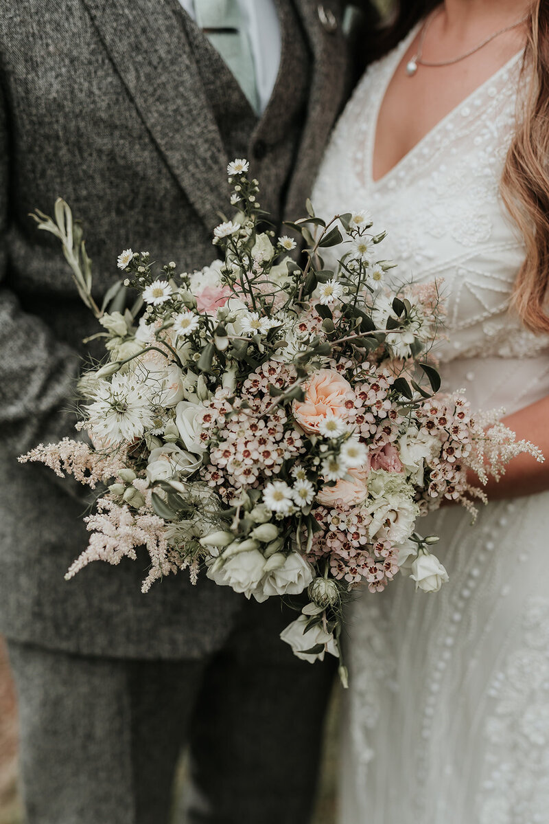 Soft blush and white flowers in a beautiful bridal bouquet