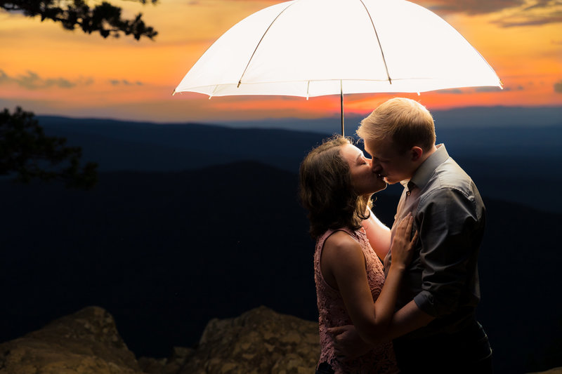 dramatic lighting engagement session on mountain top