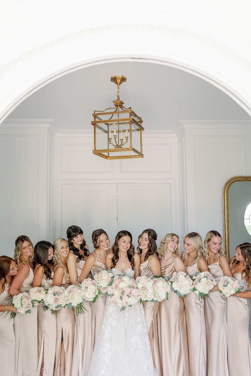 bride with bridesmaids in matching taupe dresses
