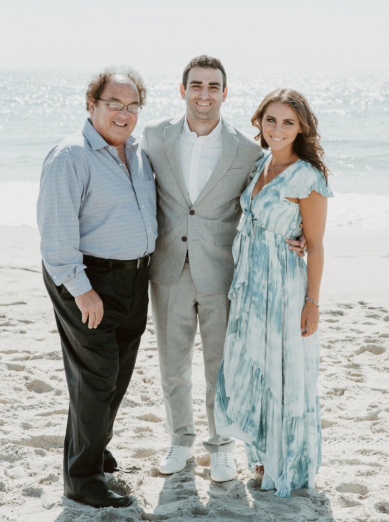 Groom with dad and sister on beach in California