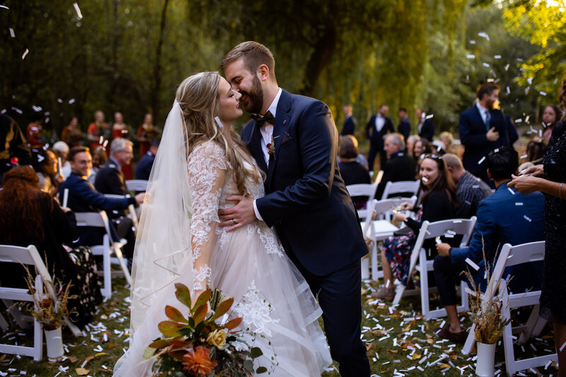 Couple having their first kiss, colorful wedding Oregon Coast Elopement and Wedding Photographer