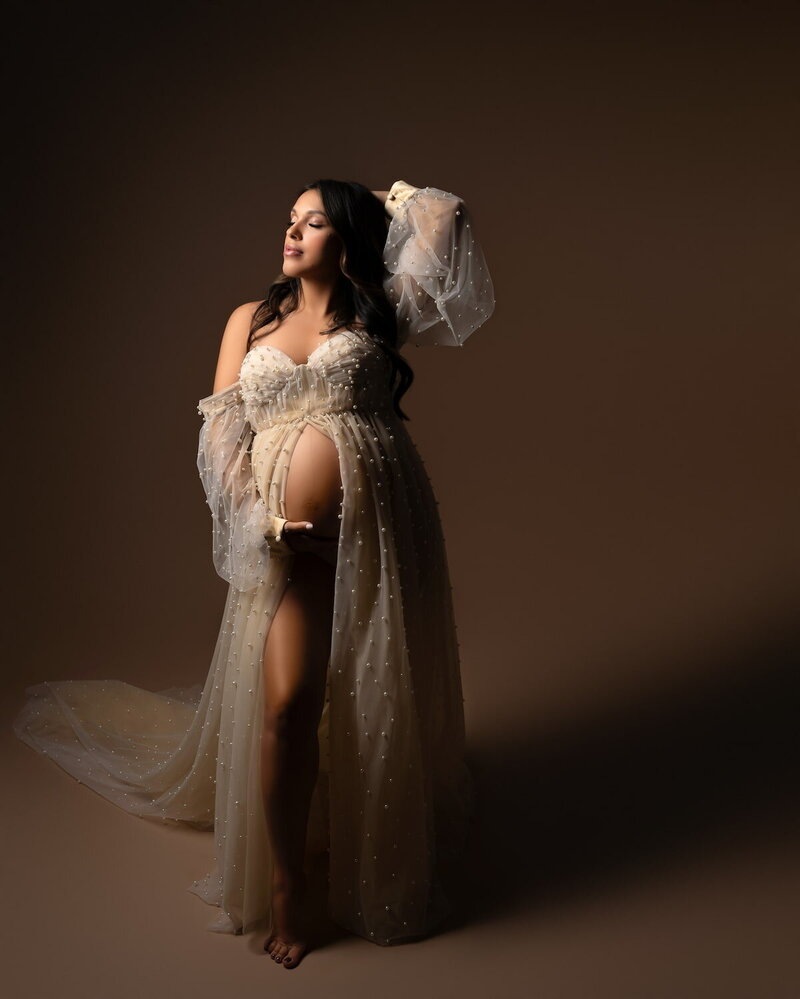Strapless beige tulle dress with voluminous texture, photographed on neutral backdrop