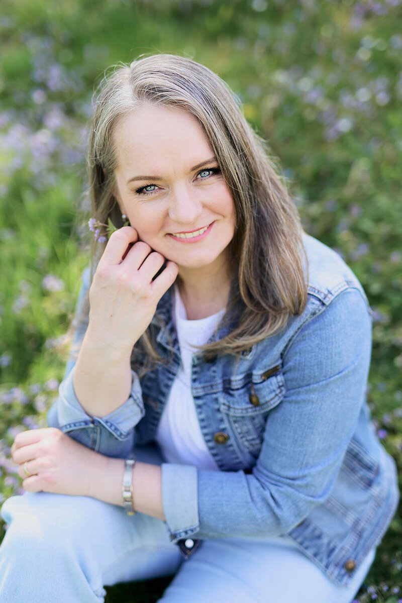 Portrait of Renata Jaroscakova from Real Joy Photography in a casual  clothing sitting in the garden, smiling to the camera