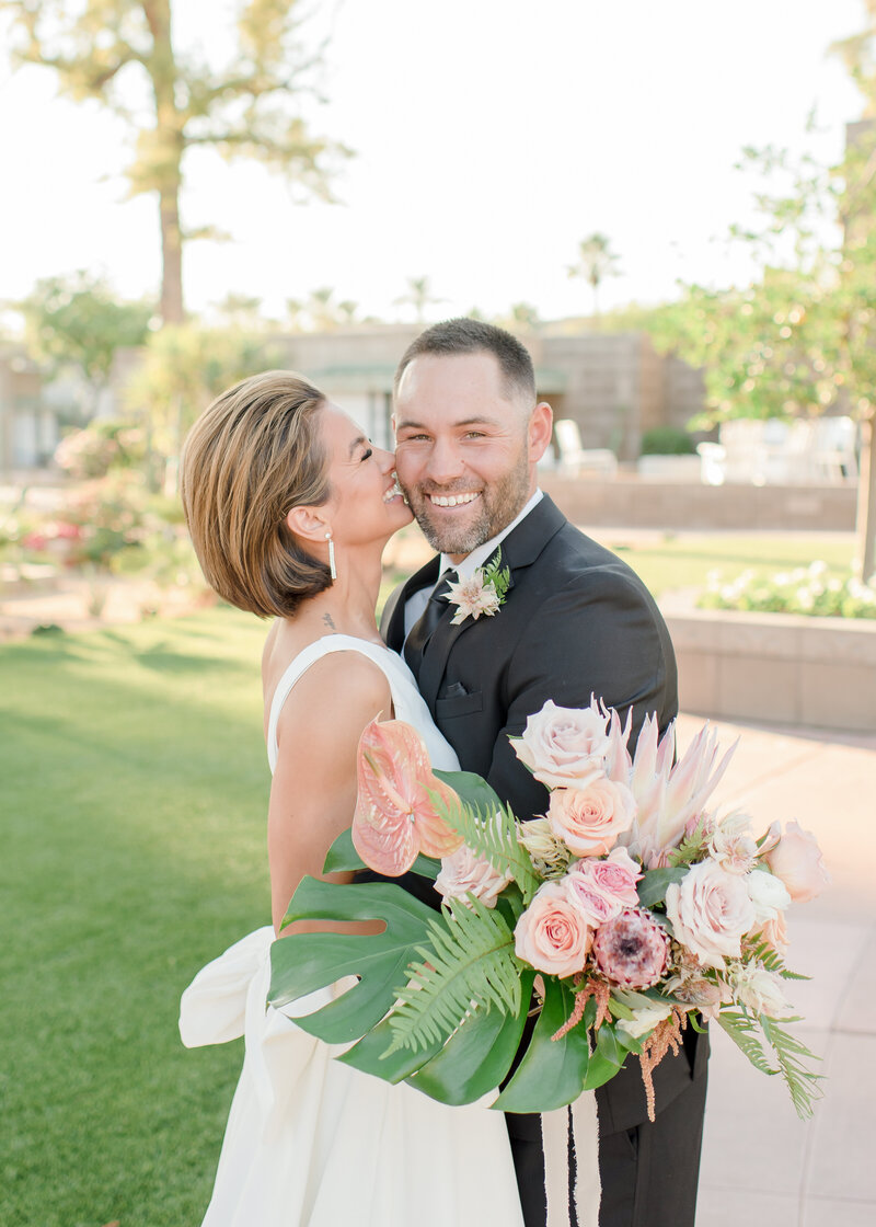 bride smiling at her husband at their coastal wedding in florida. 