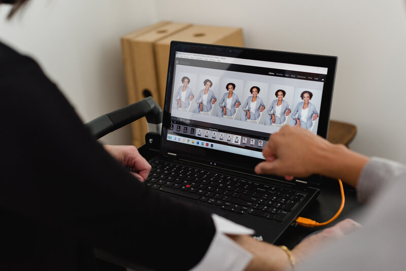 a photo of Ottawa Headshot Photographer JEMMAN Photography COMMERCIAL assisting a client select photos on the laptop