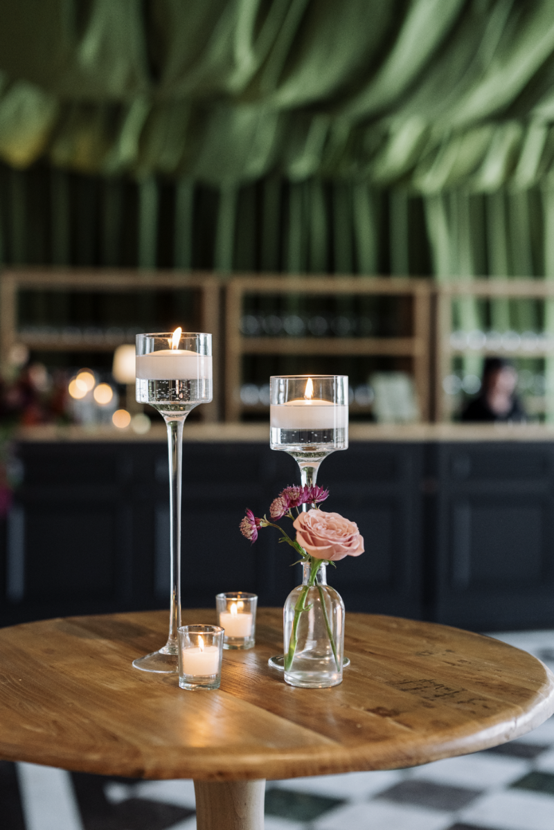 Wedding table decorated with candles and floral centerpieces - The Distillery NC wedding venue.