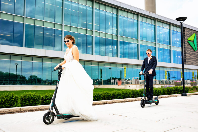 A wedding couple rides scooters in Downtown Toledo Ohio