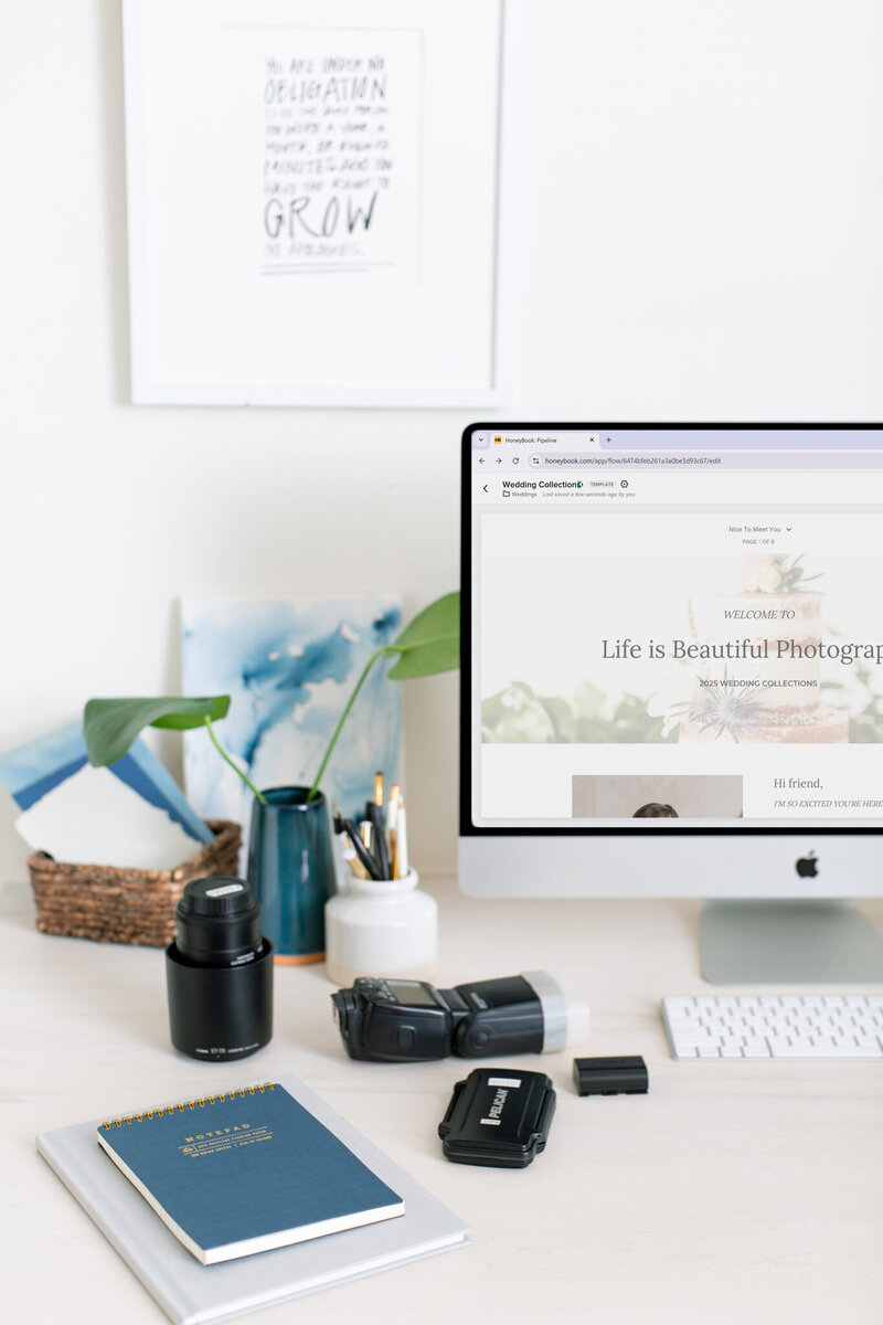 Desktop setup with HoneyBook project overview screen and neutral office decor