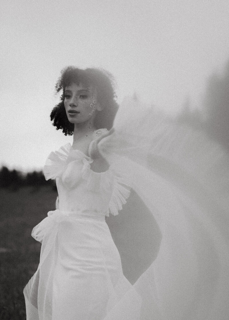 girl twirling arms while holding wedding dress