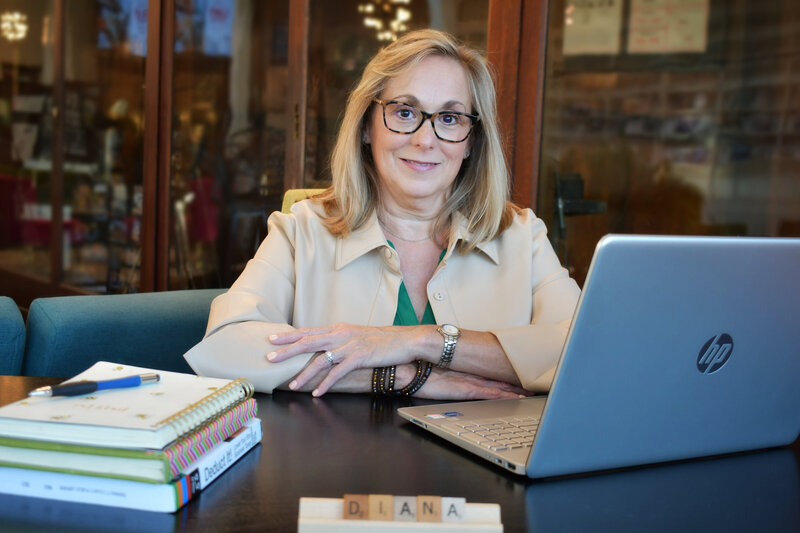 Diana Duggan at desk with laptop