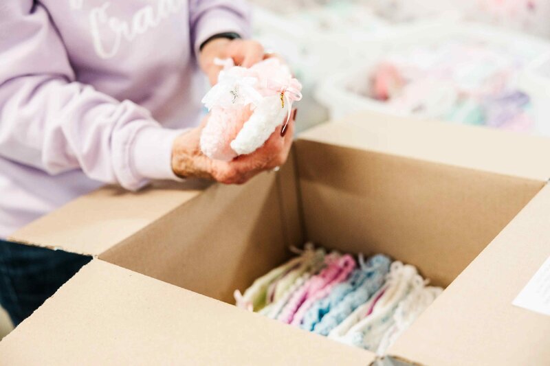 volunteer prepares stillborn miscarriage cradle box for hospitals