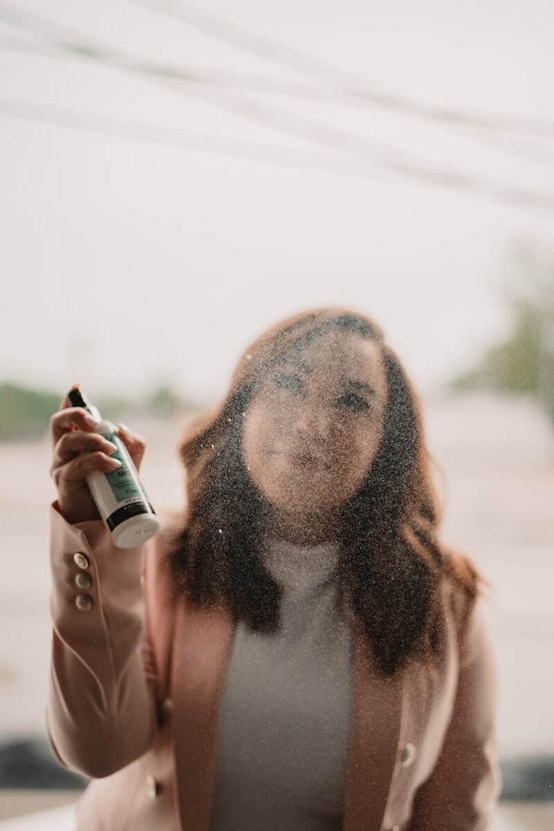 Emily spraying skincare mist