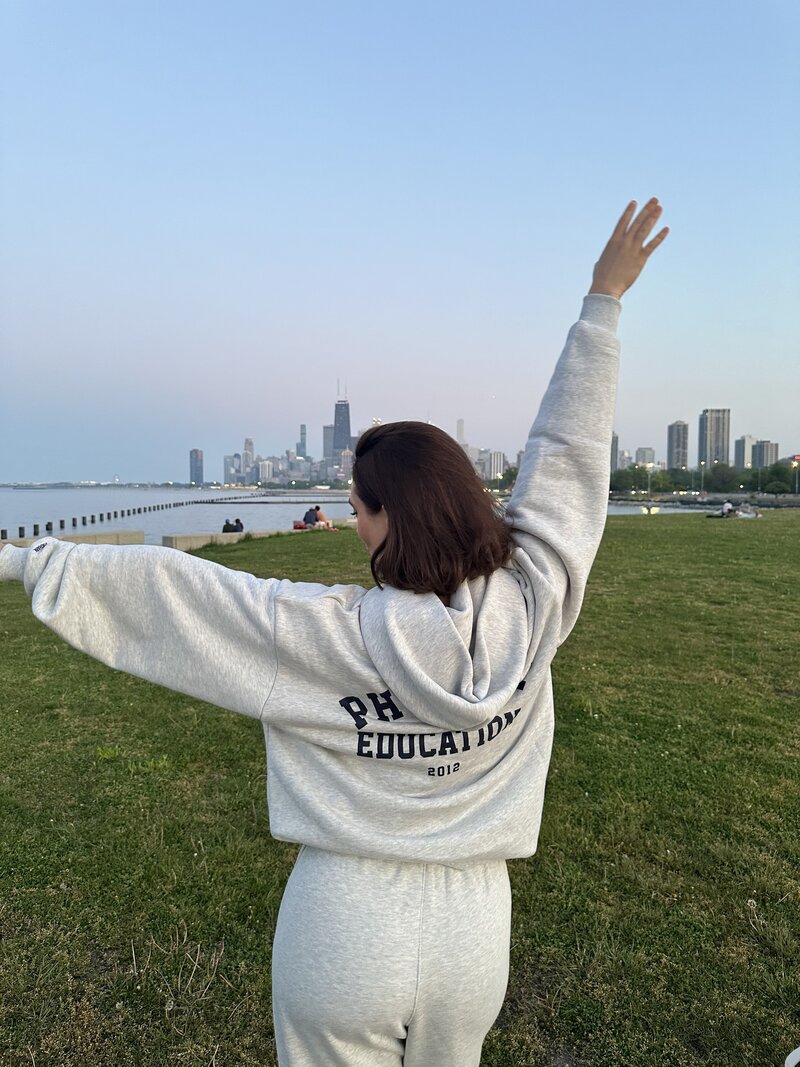 Picture of women posing with the Chicago skyline in background during sunset