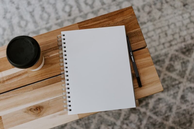 blank note pad on a wood bench