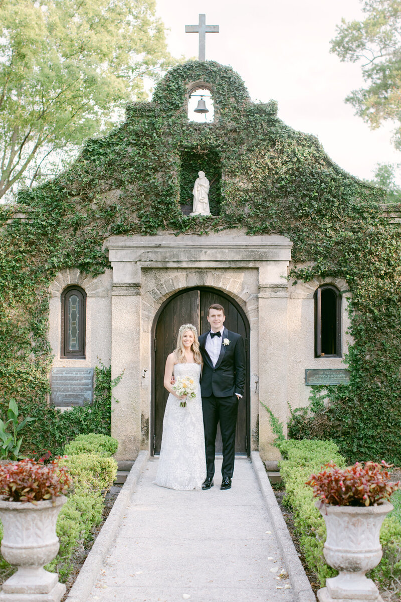 Newlyweds outside a historic ivy-covered chapel, planned by The Eventful Gals for a timeless Northeast Florida wedding.
