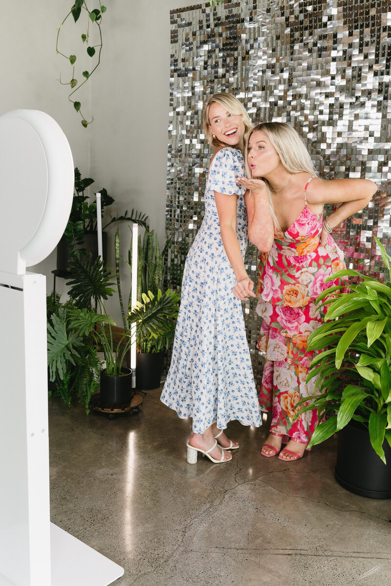 Women using a digital photo booth at brand launch