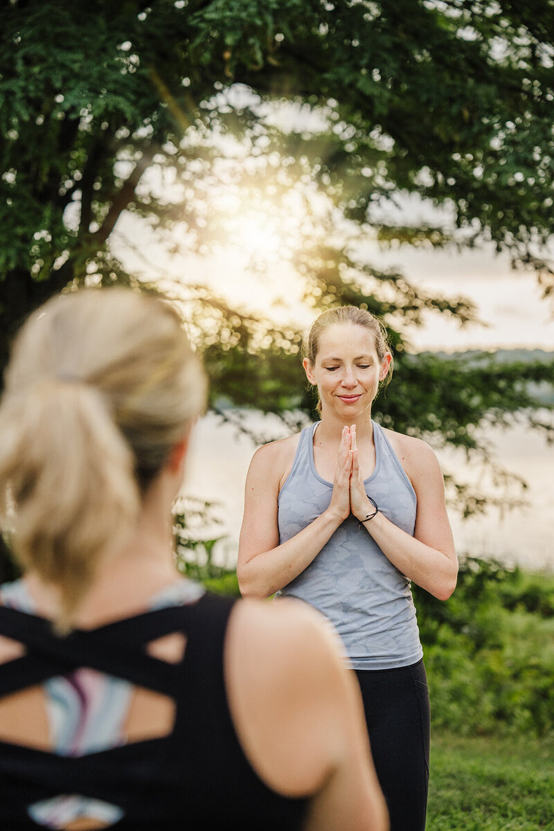 yoga instructor leads a class at sunrise