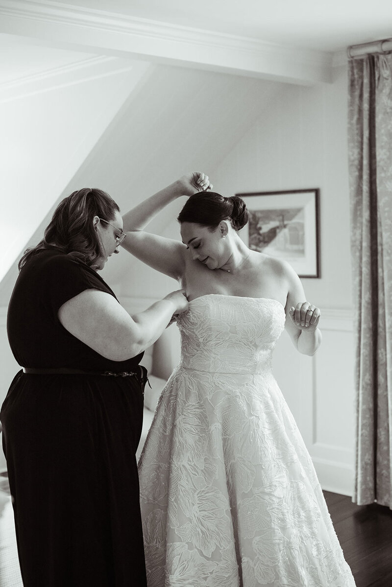 Rachel helping bride with her wedding dress