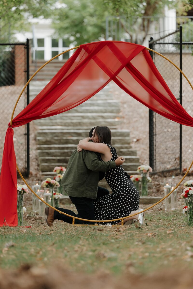 Couple hugging after the proposal in Marietta
