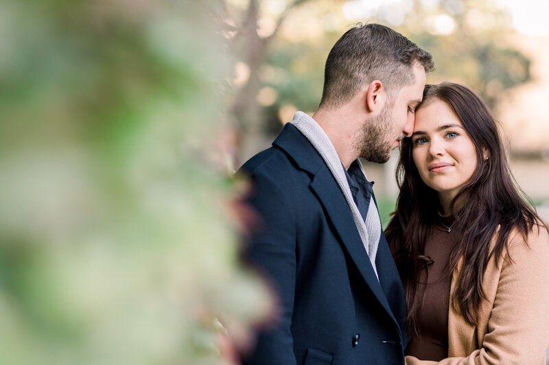 Engagement Photo of a couple with forehead touching  and the girl is looking at the camera - Shot by Toronto Wedding Photographer