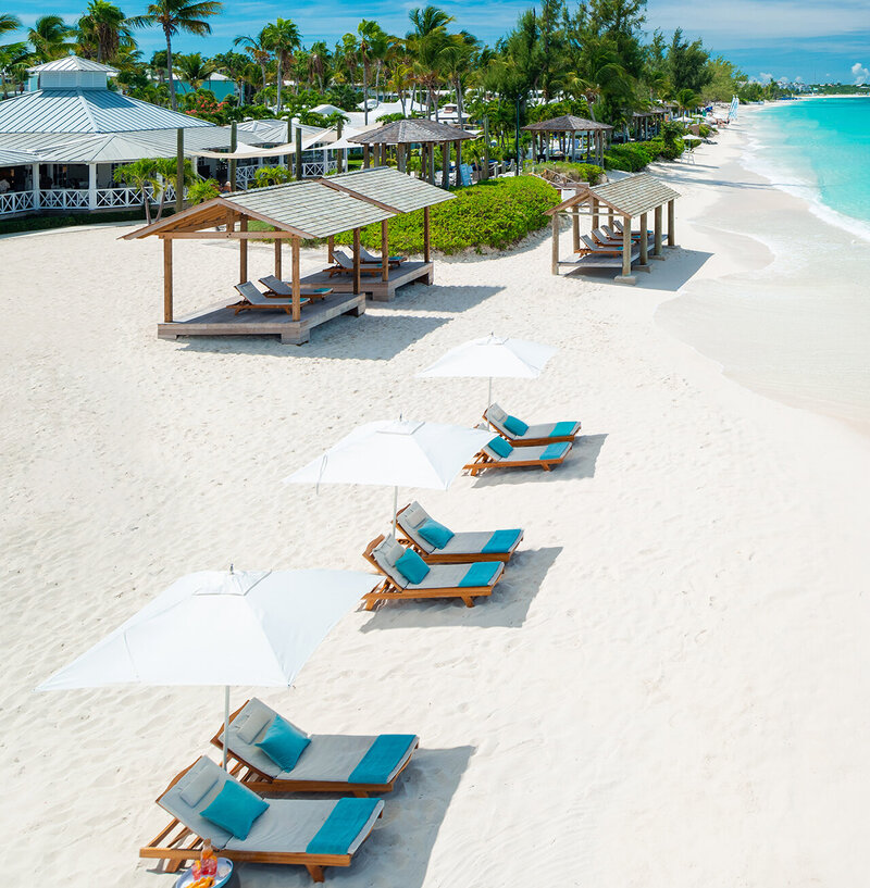 Women-With-Suitcases-Beaches-Turks-and-Caicos-Beach-with-loungers