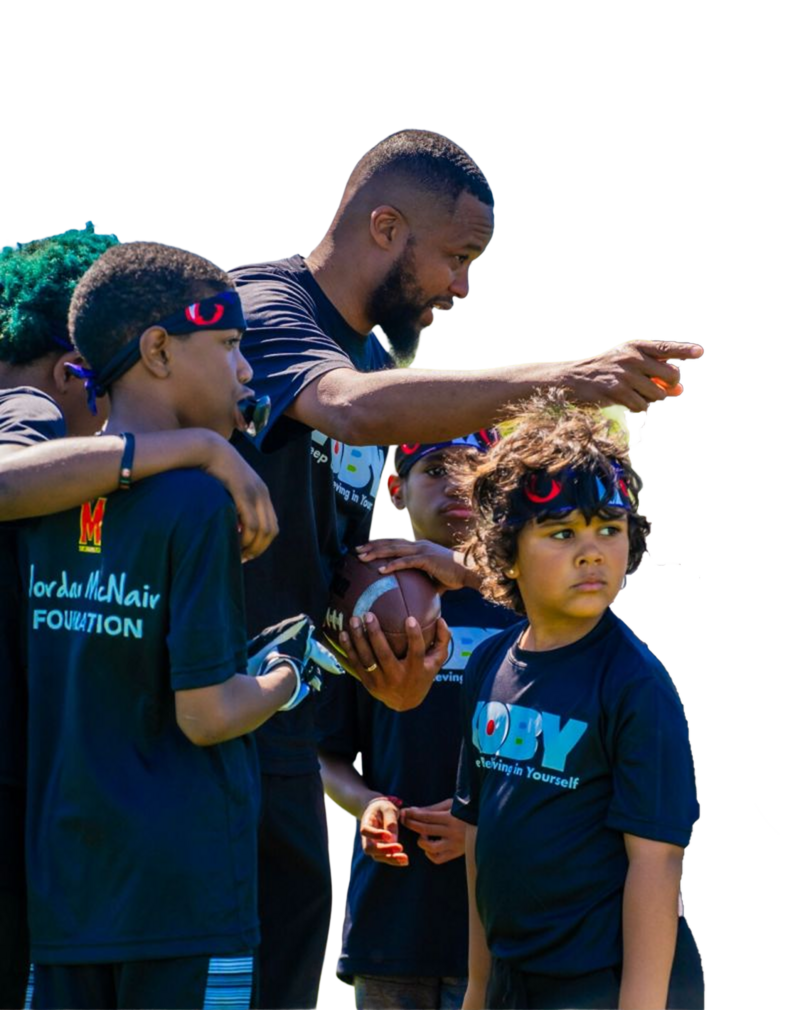 Coach directing young boy football players