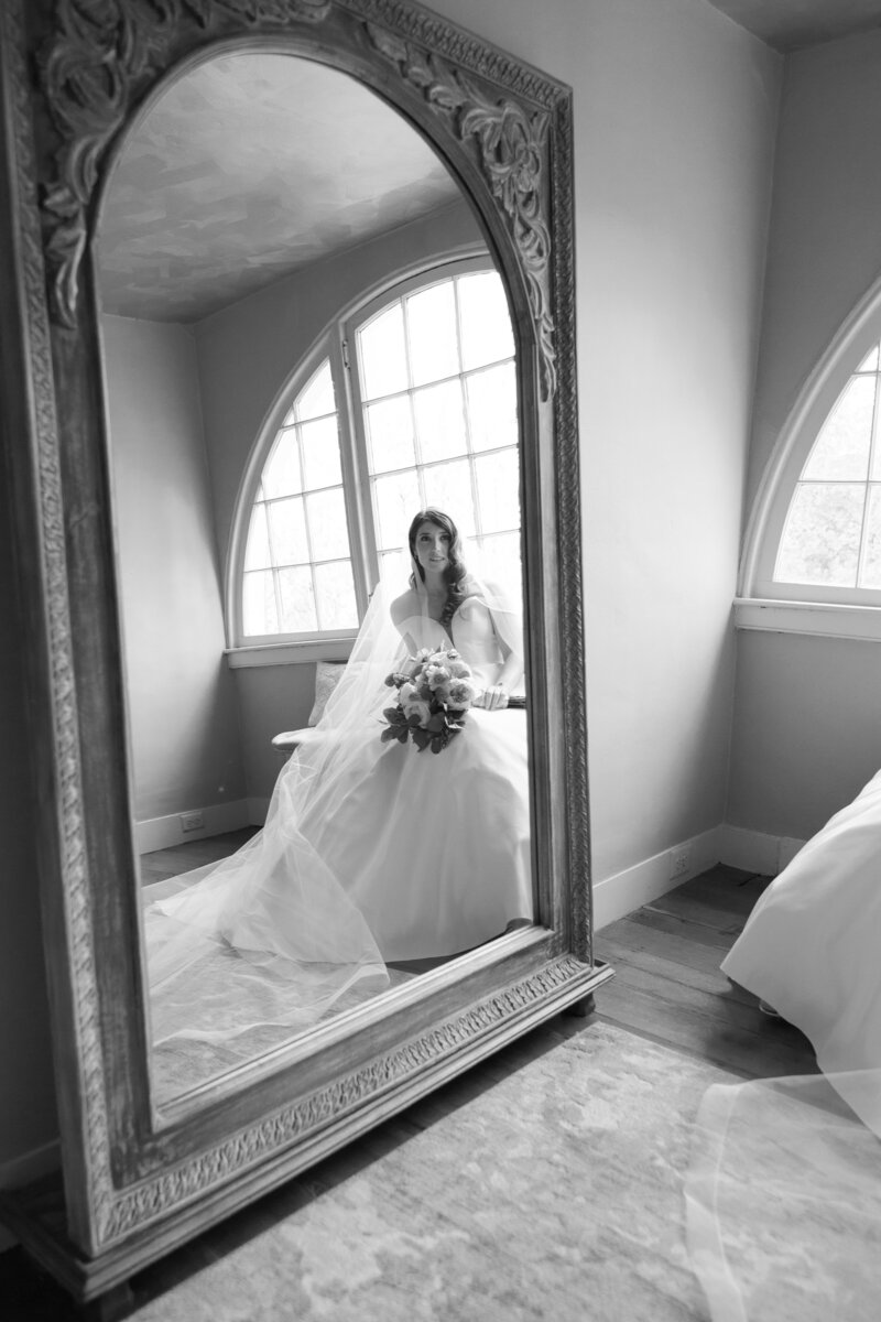Bride looking in a mirror at Elkridge Furnace Inn