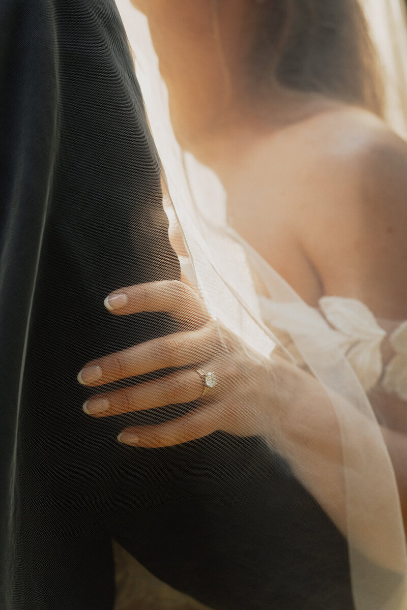wedding and engagement ring on brides hand under her veil during wedding portraits in the Comox Valley by Latitude 49 Photography