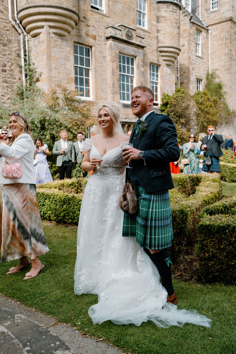 Couple walking through Glenapp Castle 
