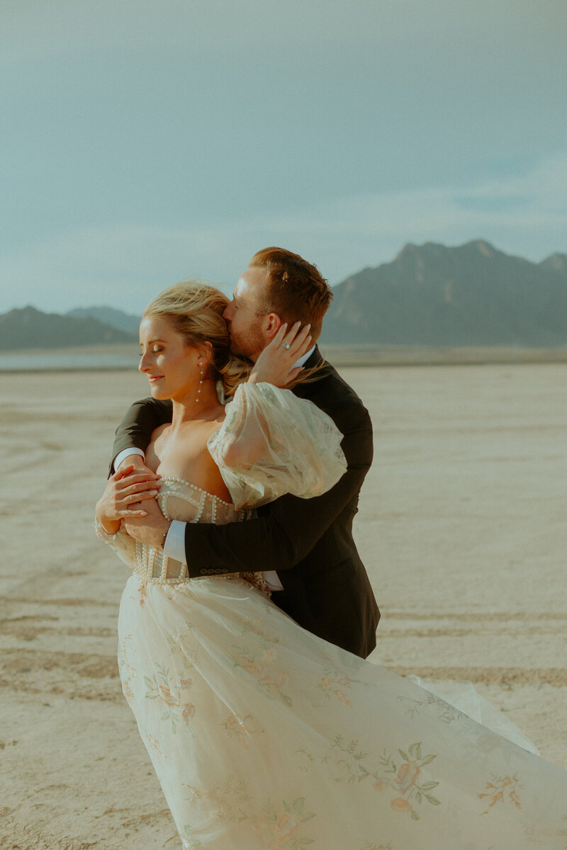 woman and man wedding posting on lakebed