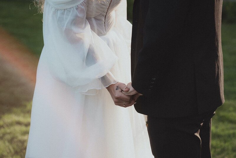 Bride and groom holding hands at their wedding at Tupper Manor. Photography by Rhode Tripper Photography
