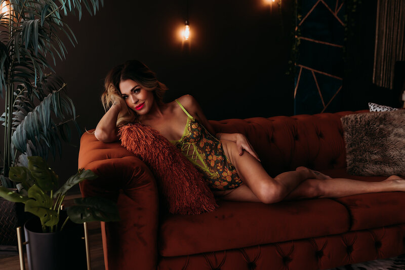 boudoir photography client laying on bed posed sexy