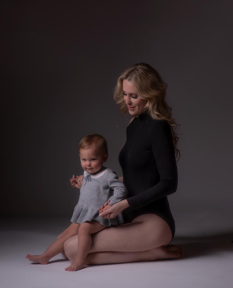 Mom and daughter playing during a mommy and me photoshoot