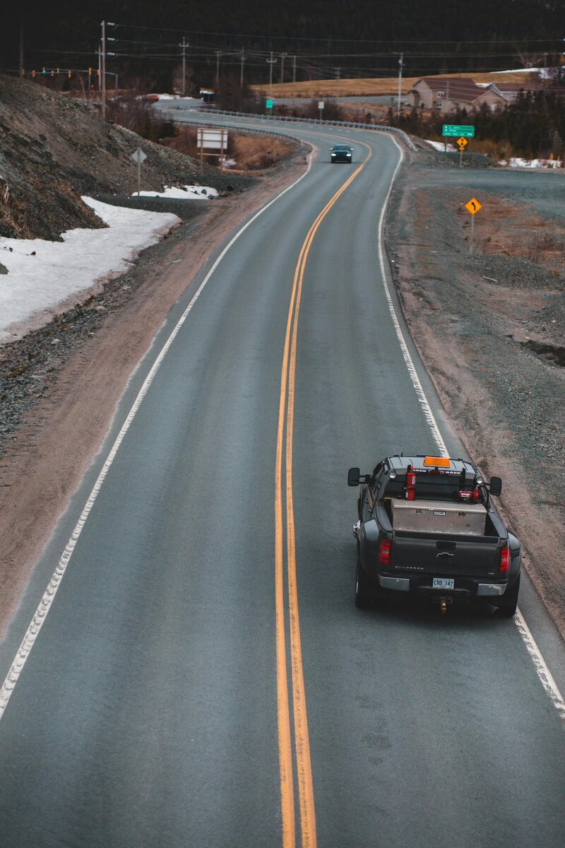 Truck driving down road