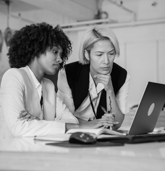 Women of a change consultancy working on their Macbook together