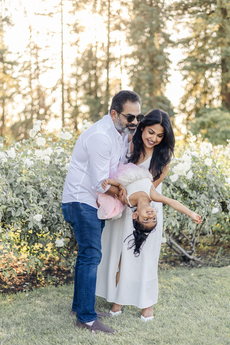 family-dipping-toddler-rose-garden-golden-hour