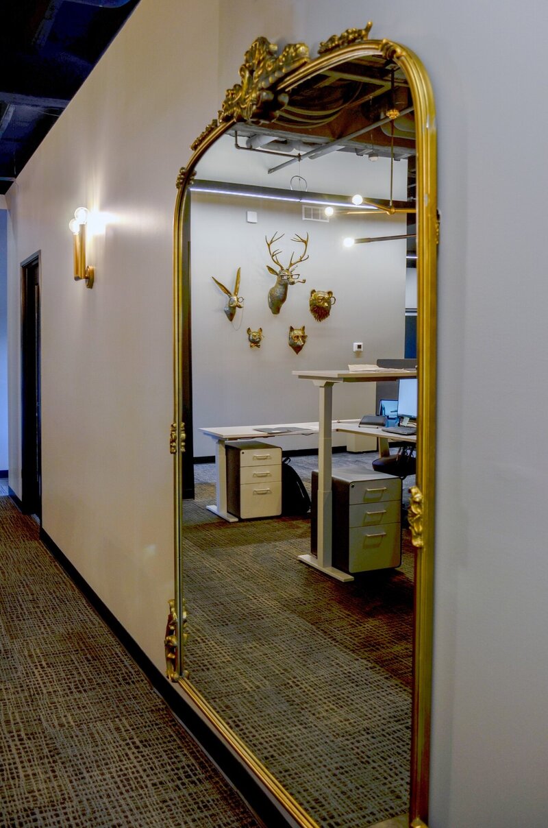 Large mirror reflecting an office space