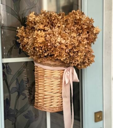 dried limelight hydrangeas in door basket hung on blue front door on Johns Island South Carolina. 