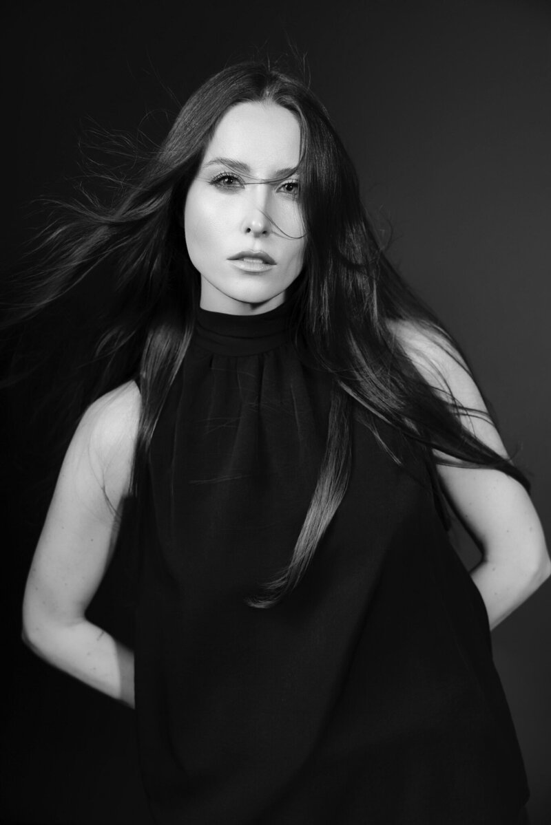 Black and white portrait of fashion and beauty photographer Lisa in confident pose