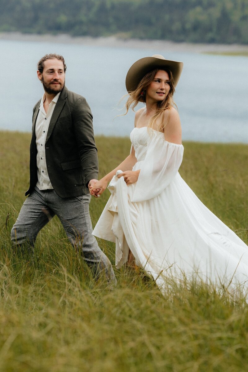 Couple laughing together during a misty Alaskan mountain elopement.