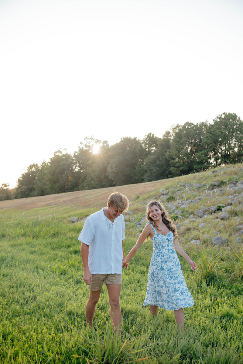 texas couple pose in a field together during their senior photoshoot